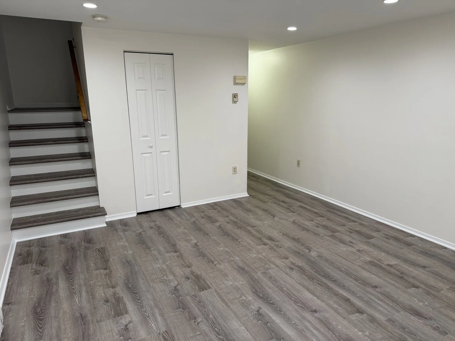Bright walls, wood-look floors and a coordinating staircase.